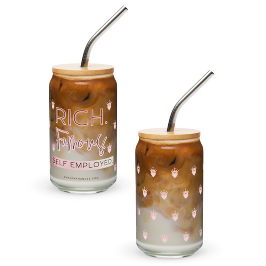 Two glass tumblers with bamboo lids and metal straws, filled with a layered drink.